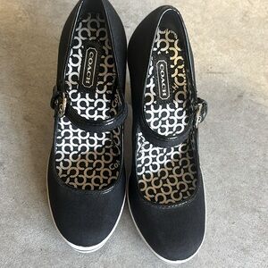 Coach black and white Cassandra pumps.